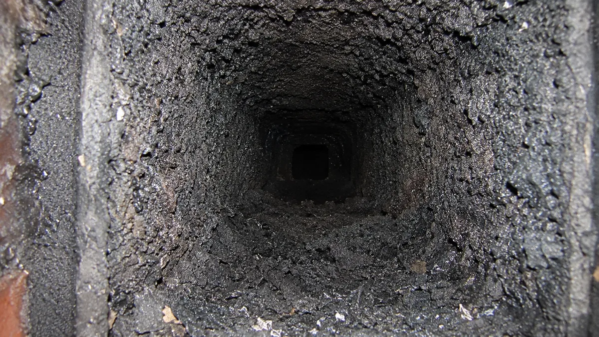 Soot buildup inside a dirty chimney flue